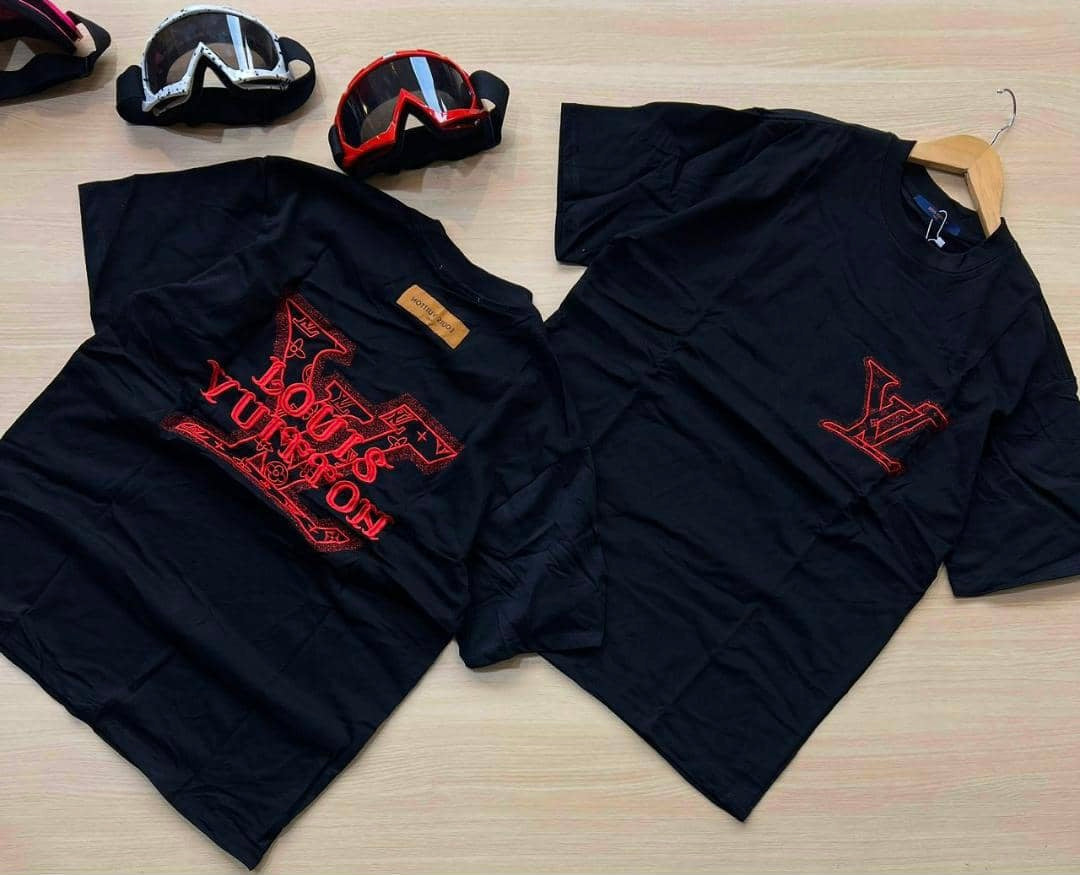 Black Louis Vuitton-inspired T-shirt with red embroidered logo on the front and back, featuring a classic crew neck and short sleeves, laid flat on a wooden surface.