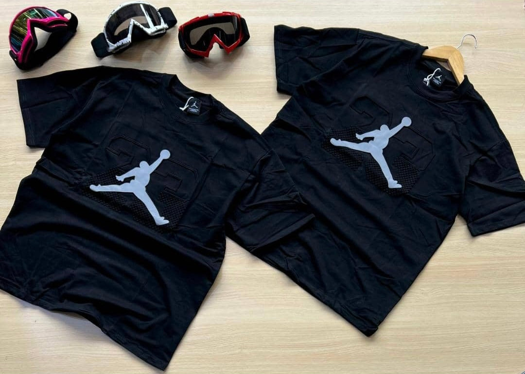 A black Jordan t-shirt featuring the iconic Jumpman silhouette and the number 23 in a stylish graphic design.